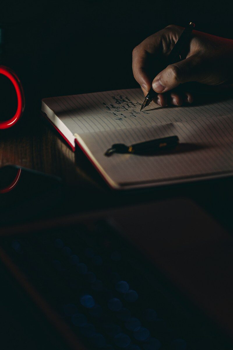 Person writing on white paper